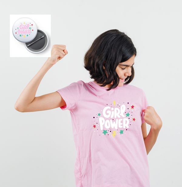 Little girl showing winner gesture in pink t-shirt and looking b